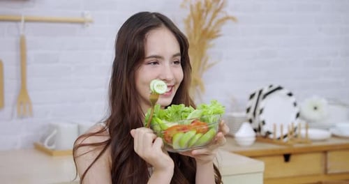 Cheerful Woman Enjoys Healthy Salad at Home