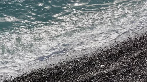 Azure Water Beats on a Pebble Beach at Sunset Sea Foam Sun Reflections on Water Not a Soul