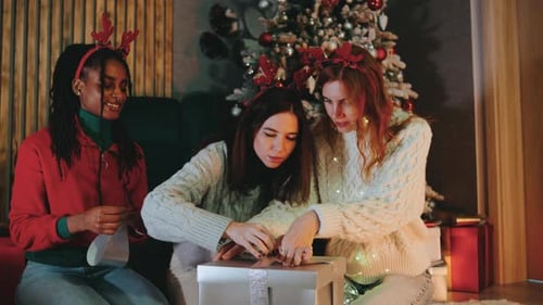 Women Friends Together Opening Christmas Present