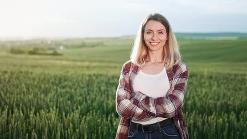 Seductive Blonde Lady Standing on Field Looking at Camera Smiling