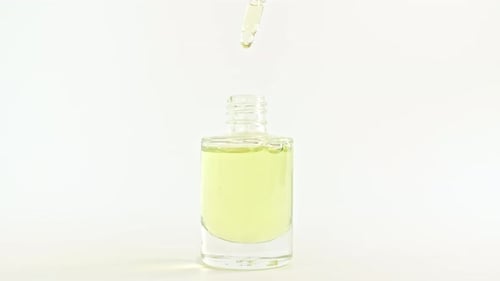Dropper Fills Vial with Yellow Beauty Serum