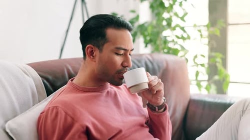 Young Adult Relaxing at Home With Drink