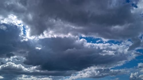 Stormy Clouds Moving Across Bright Blue Sky