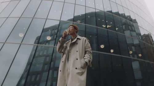 Asian Man Drinking Coffee in City