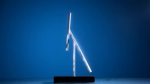 Magnetic Pendulum Balancing on Blue Background
