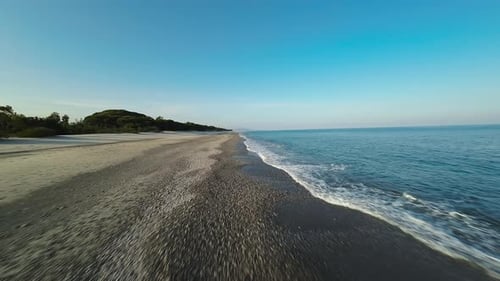 Flying Over Calm Ocean Beach