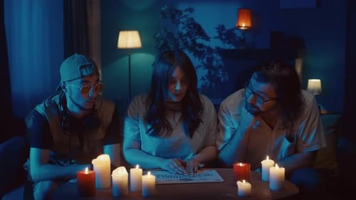 Video Capturing a Group of People Having an Ouija Board Session Seance Two Young Men Look Bored and