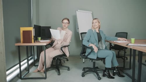 Colleagues work together in office setting with focus on tasks and communication at workplace