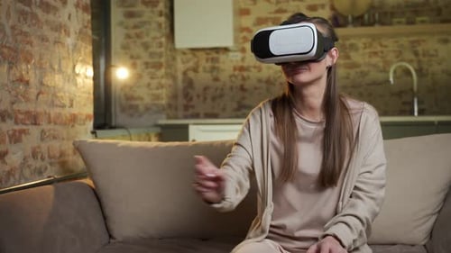 Woman Using Virtual Reality Headset on Couch