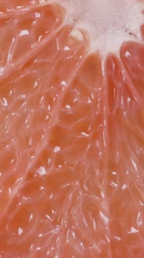 Vertical. Light Falls Differently on the Red Flesh of Grapefruit, Macro.