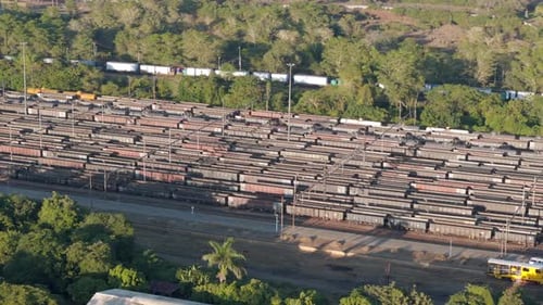 Drone orbits above abandoned old rusting railway train containers in South Africa