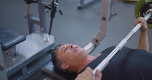 Gym Workout Bench Press Middle Aged Caucasian Man Trains His Pectoral Muscles in the Gym