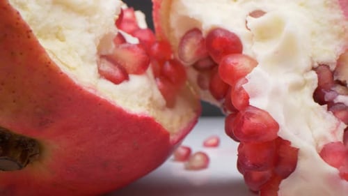 Slider view of splitted pomegranate into pieces. Fresh, healthy snack.