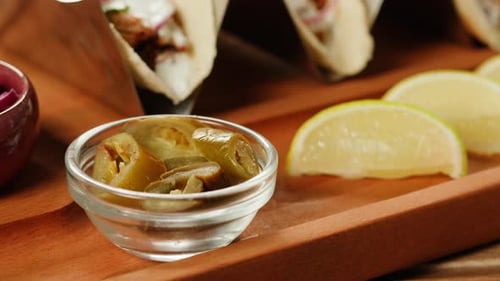 Tacos with Pickled Jalapenos and Limes on Cutting Board