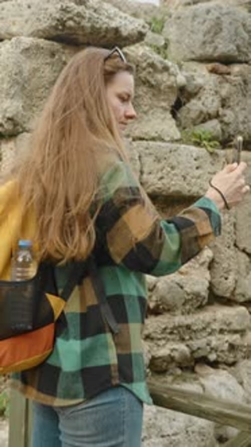 Woman Taking Photo at Ancient Ruins