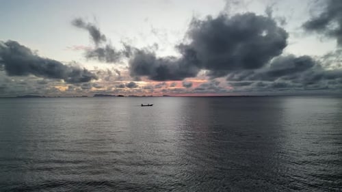 Aerial shot of a drone motorboat flying forward over the sea during sunset