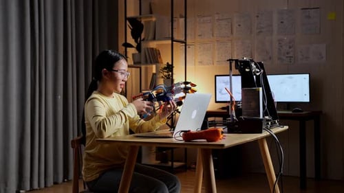 Young Person Working with Robot and 3D Printer