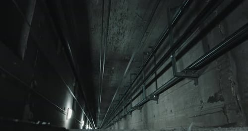 View Down Elevator Shaft with Cables and Guide Rails Perspective