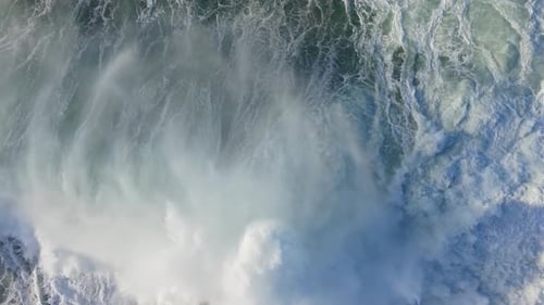 Powerful Ocean Waves Creating Foamy Patterns - Aerial Top Down, Slow Motion