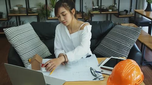 An architect or engineer uses a vernier to measure the size of a house model. Architectural concept.