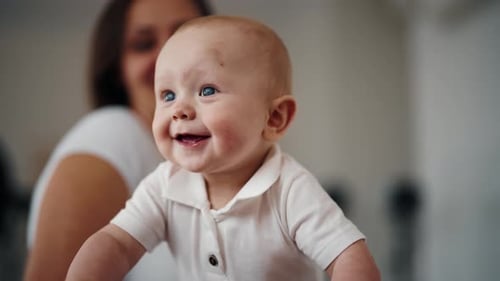 Portrait of Active Happy Cute Laughing Smiling Baby Boy at Home with Mother