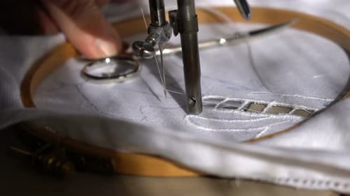 An Old Woman is Working with a Sewing Machine