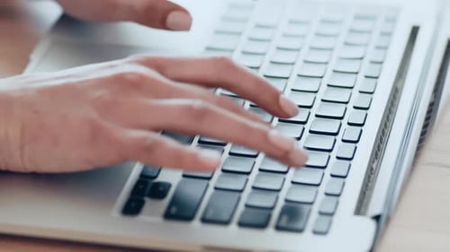 Hands Typing on Laptop Keyboard Close Up