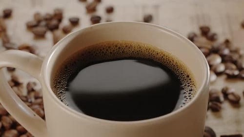 Close-Up of a Mug of Coffee with Beans