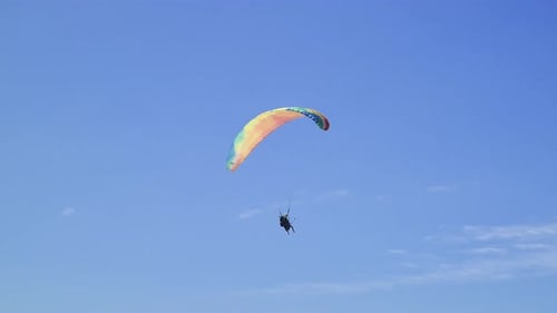 Paragliding tandem flight scene with people having fun in the sky and doing extreme sports aerial st