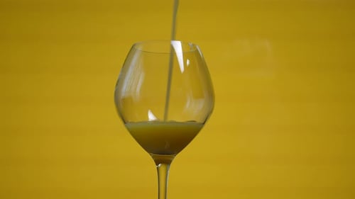 Orange Juice Being Poured into a Wine Glass
