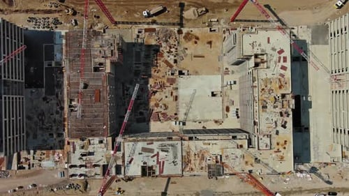 Aerial View of Construction Site with Cranes and Buildings
