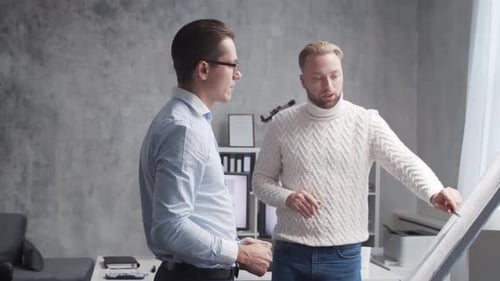 Architect and His Colleague Work in Loft Using Drawing Board Workplace of Young Engineer in Modern