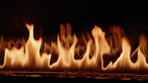 Real-time gas-powered flames flicker from a luxury gas fire place. The flames create a dramatic and