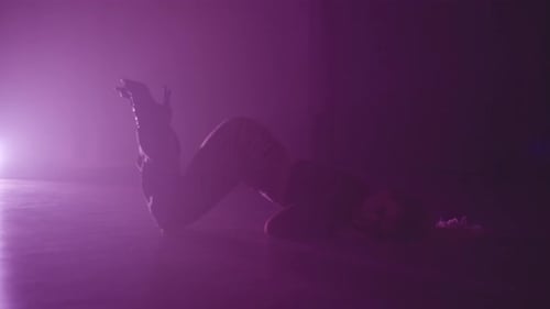 Expressive Woman Silhouette Dances in Fog