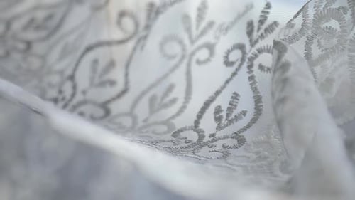 Wedding Rings Symbolizing Love on Lace Fabric