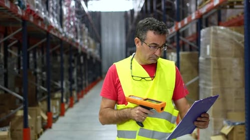 Man Taking Inventory in a Modern Storage Warehouse