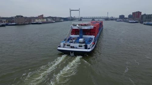 Belicha Cargo Ship Cruising Near Dordrecht City In Netherlands. Aerial Wide Shot