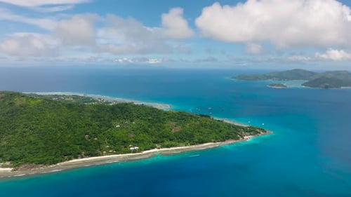 Tropical Island Coastline with Turquoise Waters and Green Hills La Digue Seychelles