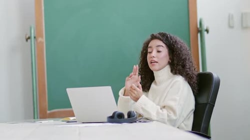 Young Female School Teacher Online Tutor Sitting at Desk Teaching Remote Class