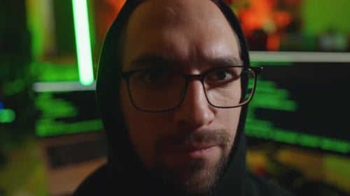 Hacker Writing Code Cracking Computer Portrait Close Up Man Programmer in Hoodie Cracks System Using