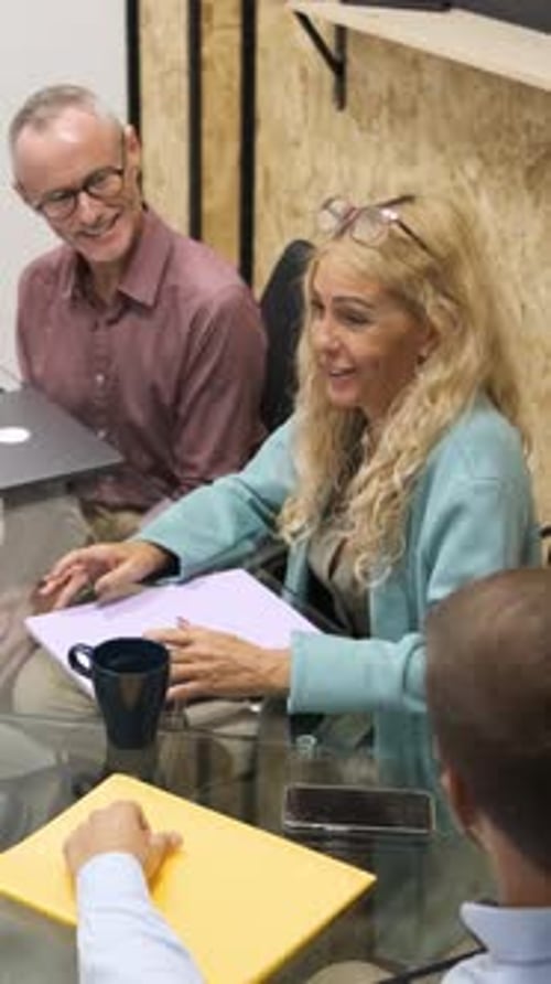 Professionals Collaborating on Project in Modern Office