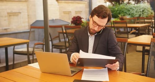 Busy Professional Man Working at Outdoor Cafe