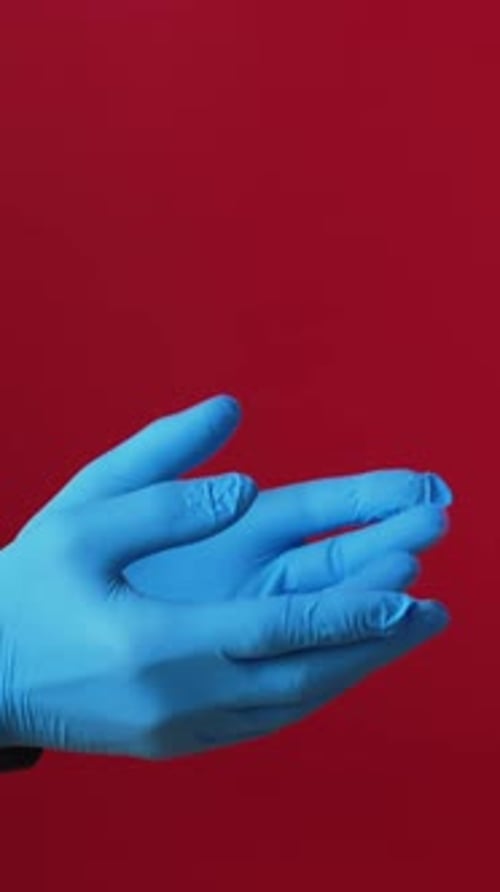 Hands With Gloves Giving a Birthday Present