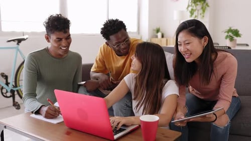 Friends Working Together on Laptop and Tablet