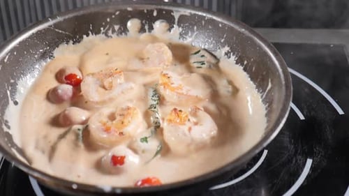 Shrimp Simmering in Creamy Sauce with Tomatoes and Spinach