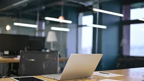 Young Businesswoman Coming and Sitting in Modern Office
