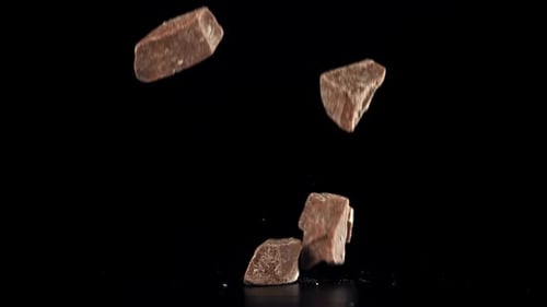 Pieces of Chocolate Fall on the Table Filmed on a Highspeed Camera at 1000 Fps