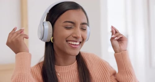 Cheerful Woman Dancing and Singing to Music at Home