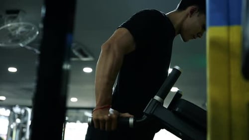 Muscular healthy man working out excwecise in gym fitness