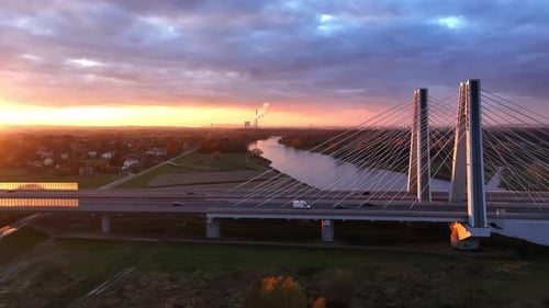 Aerial View Sunset Over Modern Bridge in Krakow The Sun Setting Behind a Modern Cablestayed Bridge